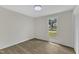 Bright bedroom features hardwood floors, a ceiling fan, and a large window at 4504 Ryegate Dr, Raleigh, NC 27604