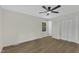Bright bedroom features hardwood floors, a ceiling fan, and a large closet at 4504 Ryegate Dr, Raleigh, NC 27604