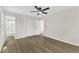 Bright bedroom features hardwood floors, a ceiling fan, and a large closet at 4504 Ryegate Dr, Raleigh, NC 27604