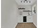 Wet bar with white cabinets, beverage cooler, shelving, and overhead lighting at 4504 Ryegate Dr, Raleigh, NC 27604