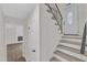 Inviting entryway featuring stairs with modern railings and a glimpse of a cozy living space at 4504 Ryegate Dr, Raleigh, NC 27604