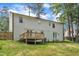 Back exterior view of a two-story house with a deck, patio, and a spacious yard at 4504 Ryegate Dr, Raleigh, NC 27604