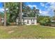 Inviting two-story white brick home featuring well-maintained lawn and mature trees on a sunny day at 4504 Ryegate Dr, Raleigh, NC 27604