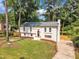 Classic two-story home with green lawn, mature trees and a paved driveway at 4504 Ryegate Dr, Raleigh, NC 27604