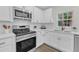 Well-appointed kitchen with stainless steel oven, white cabinetry, and quartz counters at 4504 Ryegate Dr, Raleigh, NC 27604