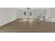Expansive living room featuring wood-look floors, a ceiling fan, bright windows, and a staircase at 4504 Ryegate Dr, Raleigh, NC 27604
