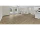 Open living room showcasing wood-look floors, abundant natural light, a ceiling fan, and a staircase at 4504 Ryegate Dr, Raleigh, NC 27604