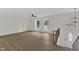 Spacious living room with wood-look floors, ceiling fan, a modern light fixture, and bright, natural light at 4504 Ryegate Dr, Raleigh, NC 27604