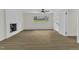 Open living room with hardwood floors, fireplace, and abundant natural light at 4504 Ryegate Dr, Raleigh, NC 27604