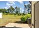 Spacious backyard with lush green lawn, mature trees, and a patio area perfect for outdoor relaxation at 5031 Eagle Stone Ln, Raleigh, NC 27610