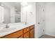 A bathroom with a double sink vanity and cabinets features a large mirror, tub-shower, and neutral finishes at 5031 Eagle Stone Ln, Raleigh, NC 27610