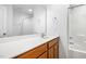 Bathroom with a wide mirror, wood vanity, and a shower-tub combination with white tiling at 5031 Eagle Stone Ln, Raleigh, NC 27610
