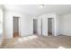 An empty bedroom has neutral carpeting, white walls, and three doorways at 5031 Eagle Stone Ln, Raleigh, NC 27610