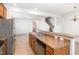An open eat-in kitchen with stainless appliances, tile flooring, and granite counters looks out to the living areas at 5031 Eagle Stone Ln, Raleigh, NC 27610