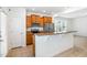 An eat-in kitchen features wooden cabinets, stainless steel appliances, and a breakfast bar with granite countertop at 5031 Eagle Stone Ln, Raleigh, NC 27610