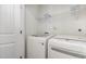 Laundry room equipped with a washer, dryer, and shelving for organized storage at 5031 Eagle Stone Ln, Raleigh, NC 27610