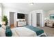 A staged bedroom suite boasts a large bed, modern decor, and access to the bath and walk-in closet at 5031 Eagle Stone Ln, Raleigh, NC 27610