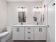 Modern bathroom featuring a double vanity with white cabinets, granite countertop, and sleek black hardware at 515 N Churton St # Ste 201, Hillsborough, NC 27278