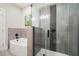 Elegant bathroom featuring a soaking tub, glass-enclosed shower, and stylish gray tile at 515 N Churton St # Ste 201, Hillsborough, NC 27278