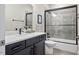 Modern bathroom featuring a dark wood vanity and granite countertop, with a tiled shower and glass door at 515 N Churton St # Ste 201, Hillsborough, NC 27278