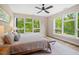 Bright bedroom with large windows overlooking lush greenery, offering a serene retreat at 515 N Churton St # Ste 201, Hillsborough, NC 27278