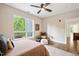 Comfortable bedroom with modern furnishings, ceiling fan, and a view of the outdoors at 515 N Churton St # Ste 201, Hillsborough, NC 27278
