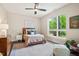 Bright bedroom with a ceiling fan, large window, and a cozy seating area at 515 N Churton St # Ste 201, Hillsborough, NC 27278