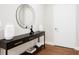 Stylish entryway featuring a black console table, modern mirror, decorative vases, and hardwood floors at 515 N Churton St # Ste 201, Hillsborough, NC 27278