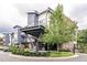 Modern apartment building with a gray and white exterior, landscaped circle drive, and covered entrance at 515 N Churton St # Ste 201, Hillsborough, NC 27278