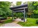 Outdoor gazebo sitting area surrounded by mature trees and landscaping at 515 N Churton St # Ste 201, Hillsborough, NC 27278
