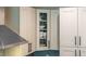 Kitchen cabinetry featuring glass-fronted cabinet with dishware on display at 515 N Churton St # Ste 201, Hillsborough, NC 27278