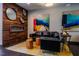 Common area with wood accent wall, fireplace, and black leather seating at 515 N Churton St # Ste 201, Hillsborough, NC 27278