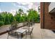 Brick outdoor patio with tables and chairs surrounded by lush landscaping at 515 N Churton St # Ste 201, Hillsborough, NC 27278
