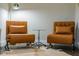Close-up of a modern sitting area with stylish chairs, glass table, and a cowhide rug at 515 N Churton St # Ste 201, Hillsborough, NC 27278