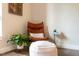 Cozy reading nook featuring a comfortable leather chair, ottoman, and decorative accents at 515 N Churton St # Ste 201, Hillsborough, NC 27278