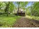 View of the home's backyard, featuring a wooden deck and mature trees at 5315 Fortunes Ridge Dr, Durham, NC 27713