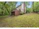 A shot of the backyard showing a wooden deck and green lawn leading up to the house at 5315 Fortunes Ridge Dr, Durham, NC 27713