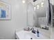 Modern bathroom with a white countertop, decorative mirror, and stylish pendant lights at 5315 Fortunes Ridge Dr, Durham, NC 27713