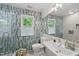Modern bathroom with a glass shower, updated fixtures, and stylish blue and gray tile at 5315 Fortunes Ridge Dr, Durham, NC 27713