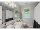 Clean bathroom with a shower, large vanity, and a window that provides natural light at 5315 Fortunes Ridge Dr, Durham, NC 27713