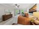 Bedroom featuring a large dresser, ceiling fan, soft lighting, and windows with backyard views at 5315 Fortunes Ridge Dr, Durham, NC 27713