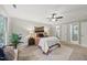 Inviting bedroom with a decorative rug, ceiling fan, and ensuite bathroom at 5315 Fortunes Ridge Dr, Durham, NC 27713