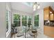 Bright breakfast nook with skylight, large windows offering lush views, and glass table and chairs at 5315 Fortunes Ridge Dr, Durham, NC 27713