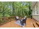 Enjoy outdoor living on this wooden deck with stylish furniture and wooded views at 5315 Fortunes Ridge Dr, Durham, NC 27713