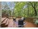 Spacious wooden deck with outdoor seating area, surrounded by lush greenery at 5315 Fortunes Ridge Dr, Durham, NC 27713