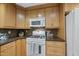 Updated kitchen featuring wooden cabinets, dark countertops, modern appliances and a tile backsplash at 5315 Fortunes Ridge Dr, Durham, NC 27713