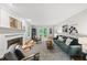 Inviting living room with fireplace, hardwood floors, stylish furnishings and backyard access through glass doors at 5315 Fortunes Ridge Dr, Durham, NC 27713