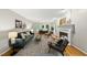 Spacious living room featuring fireplace, hardwood floors, a sofa and armchairs, and abundant natural light at 5315 Fortunes Ridge Dr, Durham, NC 27713