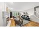 Bright and airy living room featuring hardwood floors, a fireplace, and stylish contemporary furniture at 5315 Fortunes Ridge Dr, Durham, NC 27713