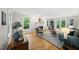 Bright living room featuring a cozy fireplace, hardwood floors, and large windows with natural light at 5315 Fortunes Ridge Dr, Durham, NC 27713